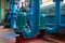 Green vertical motors with pumps on a blue colored water pipeline