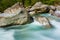 Green Verzasca river water with stones in shunshine