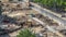 Green vibration roller compactor rolls on a stones at road construction and repairing timelapse