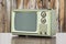 Green Vintage Television with Old Wood Wall