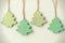 Green vintage wooden christmas trees hanging on string