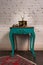 Green vintage wooden table and old golden telephone set