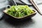 Green wakame. Seaweed salad in wooden bowl