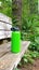Green water bottle on hiking trail