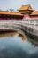 Green water canal leads to halls at Forbidden City, Beijing.