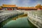 Green water canal leads to halls at Forbidden City, Beijing.