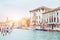 Green water channel with gondolas and colorful facades of old me