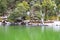 Green Water of Deoria or Deoriya Tal Lake and Snow Covered Trees in Himalayan Forest - Winter Landscape - Uttarakhand, India