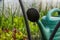 Green watering in a greenhouse. Arcs in the greenhouse. Selective focus. Blurred green background of greens, lettuce and