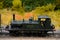 Green weathered steam engine with driver model train