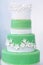 Green wedding cake decorated with white flowers