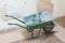 Green wheelbarrow tradesman or labourer tools for manual hand work in construction building site