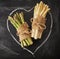 Green and white asparagus on a hand drawn heart