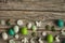 Green and white Easter eggs, candle egg, gypsum egg, poultry egg with ground, butterflles, flowers. Horizontal copy