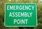 Green and white Emergency Assembly Point sign