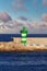 Green and White LIghthouse and Seawall