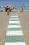 Green and white path leading to beach in Spain