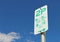 Green and white Two Hour Parking sign in a blue sky