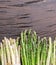 Green and white types of asparagus sprouts on wooden table.  Top view