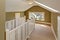 Green and white upstairs hallway with vaulted ceiling and skylight