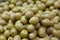 Green whole olives in oil close up