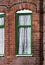 Green window, typical English red bricks house, close up. Manchester