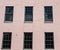 Green Windows in Pink Stucco