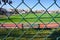 Green wire fence at the football pitch close up view