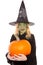 Green witch for halloween holding pumpkin