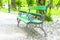 Green wooden bench in the park with poplar flower down