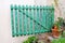 Green wooden decorative fence with floral flower elements and details / Part of the garden.