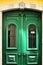 Green wooden door with metal forged details