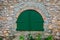 Green wooden door in the old Spanish rural house