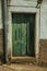 Green wooden door with peeling paint