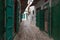 Green wooden doors of the old stores in Tetouan Medina quarter in Northern Morocco. A medina is typically walled, with many narrow