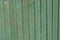 Green wooden faded old planking background with cracks