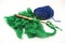 Green wool, blue thread and old spindle close-up on white background. Tools for knitting of wool