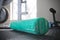 Green workout foam roller on gym floor