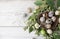 Green wreath with easter quail eggs and flowers on wooden background