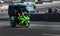 Green Yamaha sport bike Ninja travels at high speed through the city