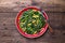 Green and yellow beans with spinach, sesame seeds and soy sauce on wooden table