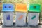 Green, yellow and blue recycle bins with recycle symbol Waste bin at the public park with copy space sign