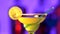 Green and yellow cocktail with lemon decortion and