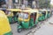 Green yellow Indian cab rickshaws in the street parking