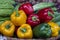 Green, yellow and red sweet peppers for sale at street food market in the old town of Hanoi, Vietnam