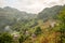 The green and yellow rice fields at the foot of the green mountains, in Asia, in Vietnam, in Tonkin, in Bac Ha, towards Lao Cai,