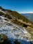 Green and yellow slopes of the mountains with snowy peaks and cableways