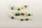 Green, yellow tramadol capsule pills on white background.Pain killer capsules called