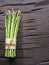 Green young asparagus sprouts on wooden table. Top view