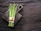 Green young asparagus sprouts on wooden table. Top view